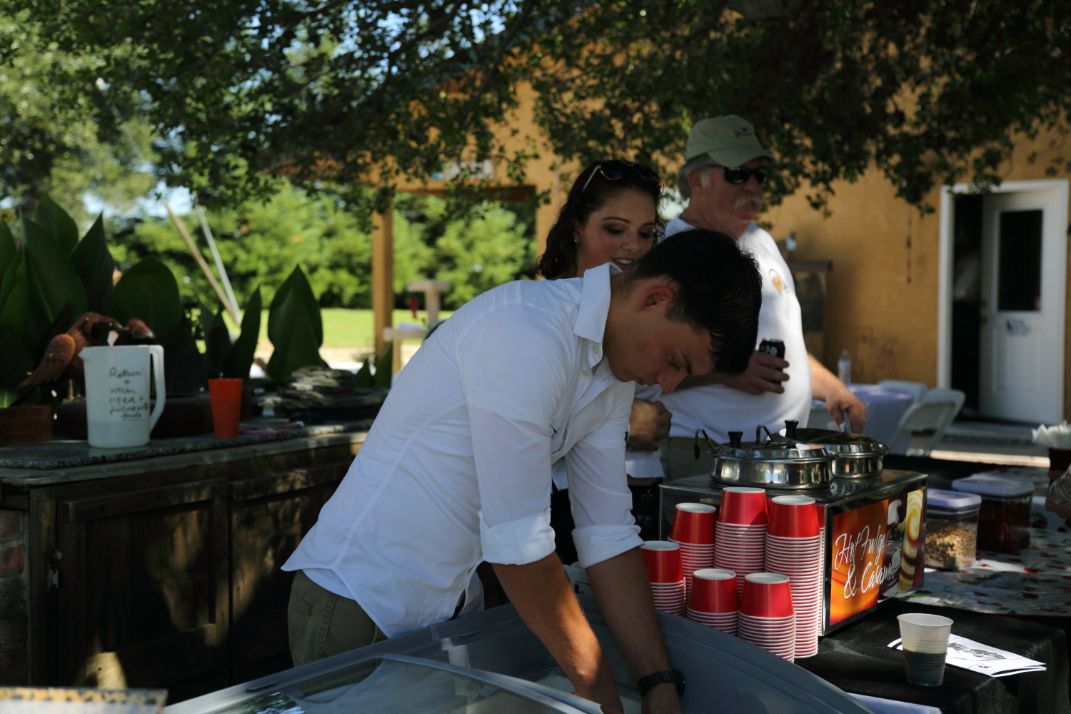 Ice cream being scooped into a cup.